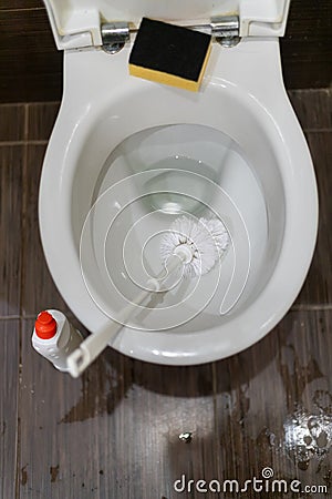 Man hand cleaning toilet with brush Stock Photo