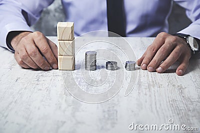 Man hand coins with cubes Stock Photo