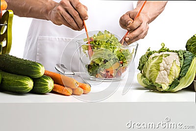 Man hand cook make mix vegetables salad on kitchen Stock Photo