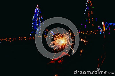 man hand firewrks Close up view,happy birthday, night party ,happy diwali,Man's hand holds sparklers, Happy New Year, Glowing Editorial Stock Photo