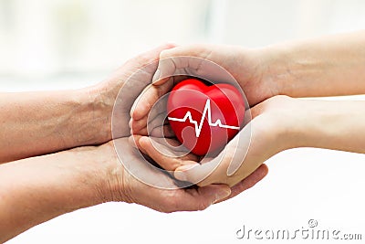 Man hand giving red heart to woman Stock Photo