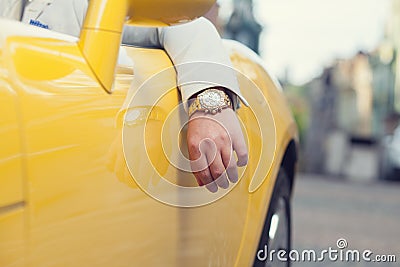 Man hand with golden watch in car Stock Photo