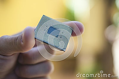 Man hand while hold a desktop pc cpu part,computer components chip Stock Photo