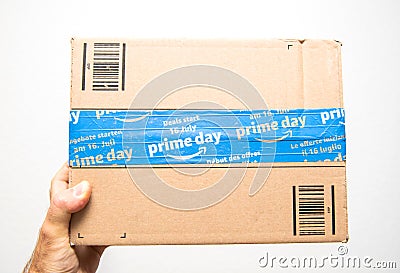 Man hand holding against white Amazon Prime Day cardboard box Editorial Stock Photo