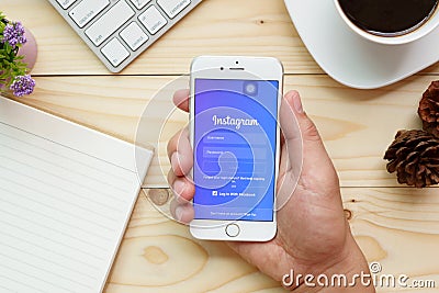 A man hand holding Apple iPhone 6s with Instagram application on the screen Editorial Stock Photo