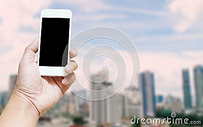 A man hand holding empty screen of smart phone blurred photo urban background internet of thing concept Stock Photo