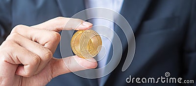 Man hand holding gold EOS coin cryptocurrency, Crypto is Digital Money within the blockchain network, is exchanged using Editorial Stock Photo