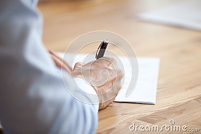 Man hand holding pen, writing notes at meeting close up Stock Photo