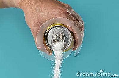 Man hand holding refresh drink can pouring sugar stream in sweet and calories content of soda and energy drinks Stock Photo