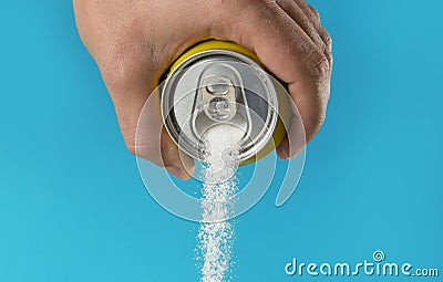 Man hand holding refresh drink can pouring sugar stream in sweet and calories content of soda and energy drinks Stock Photo