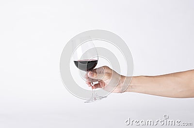 Man hand holding a wine glass on a gray background Stock Photo