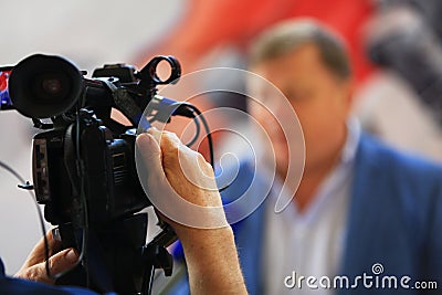 Man hand holds digital black video camera Editorial Stock Photo