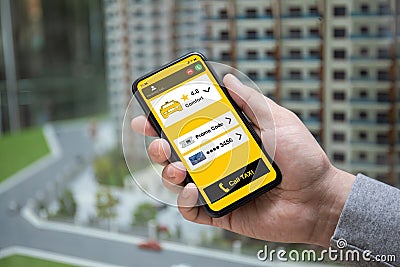 Man hand holds phone application call taxi and incoming call Stock Photo