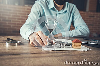 Real estate concept and hourglass Stock Photo