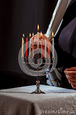 Man hand lighting candles in menorah hanukka lights candles Stock Photo