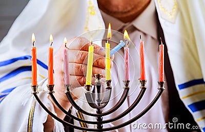 man hand lighting candles in menorah table served for Hanukkah Stock Photo