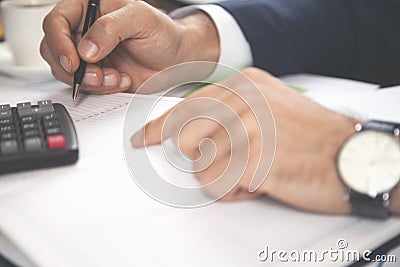 Man hand notepad with calculator Stock Photo