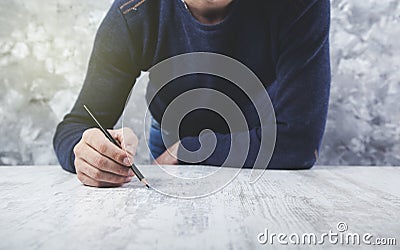Man hand pencil on table Stock Photo