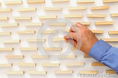 man hand pick one of wood block from many wooden blocks Stock Photo