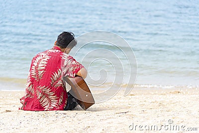 Man hand playing guitar on the beach. Acoustic musician playing classic guitar. Musical Concept Stock Photo