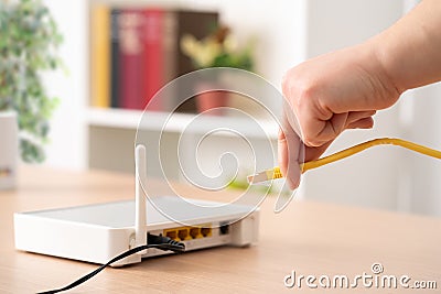 man hand plugging ethernet cable Stock Photo