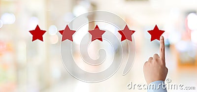 Man hand pointing red five star over blur background, customer excellent rating satisfacation, customer feedback, business concept Stock Photo