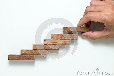 Man hand stacking up wooden block Stock Photo