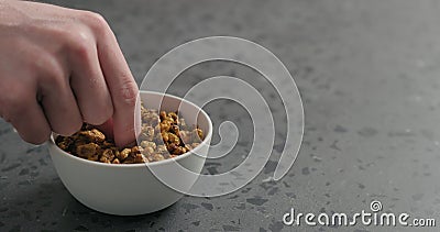 Man hand take dried seaberry from white bowl on terrazzo countertop Stock Photo