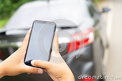 Man Hand Taking Photo Of Car Accident Through Smartphone, close up..Insurance agent using smart phone to take a photo Stock Photo