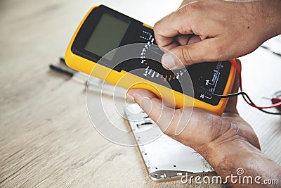 Man hand tester and phone Stock Photo