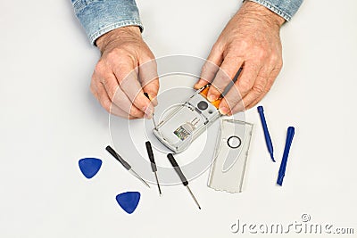 Man hand with tools repearing a smartphone Stock Photo
