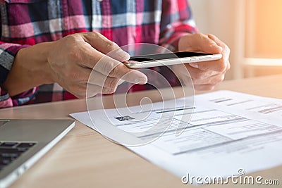 A man hand uses phone to scan bar code or qr code to pay for a credit card. Stock Photo