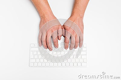 A man hand using a wireless keyboard isolated on white Stock Photo