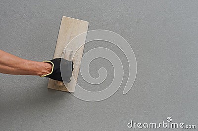 man hand wear glove plastering cement wall with copy space Stock Photo