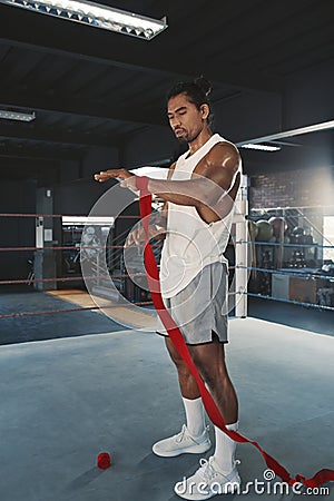 Man With Hand Wrap On Boxing Ring. Portrait Of Sportsman With Muscular Body Using Wrist Bandage For Training At Gym. Stock Photo