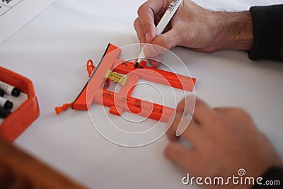 A man hand. He writing his wish on the small Torii gatese Stock Photo