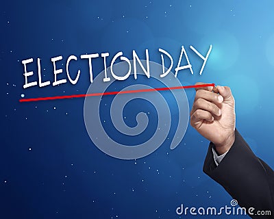 Man hand writing a 'ELECTION DAY' with gold marker Stock Photo