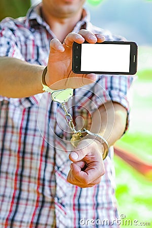 Man handcuffed outdoors in the park Stock Photo
