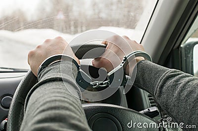 The man in handcuffs, riding in the car. Stock Photo