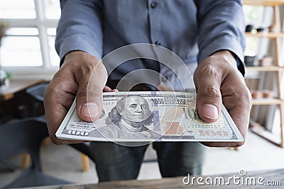 Man handed dollar bills to you, American money in hand, Cash in hands, Income and Business concept Stock Photo