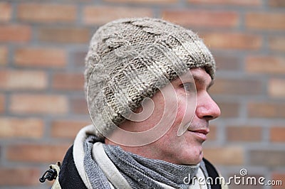 Man in handmade knitted winter beanie hat Stock Photo