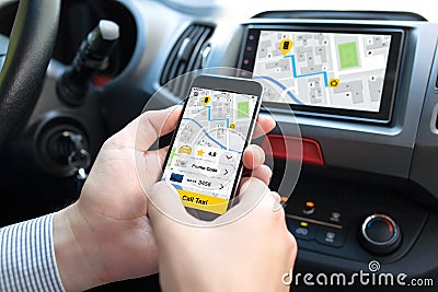 Man hands in car holding phone with application call taxi Stock Photo