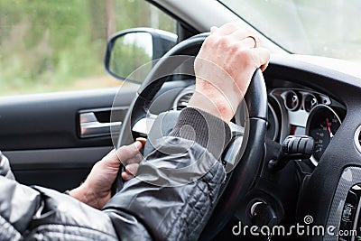 Man hands on car wheel Stock Photo