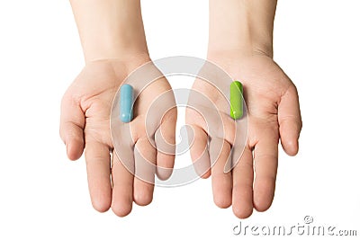 Man hands giving two big pills. Blue and green. Make your selection. calm nerves and health. Choose your side Stock Photo