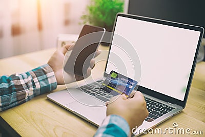 Man hands holding Credit card and phone,laptop with shoping online Stock Photo