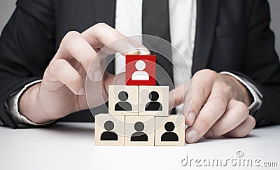 Man hands holding cube with many human symbol, leadership and corporate hierarchy concept, copy space Stock Photo