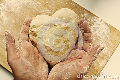 Man hands holding homemade heart shaped pastry Stock Photo