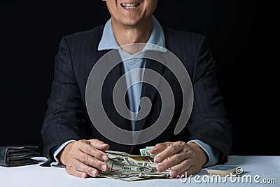 Man hands holding and sweeping money,business concept. Stock Photo