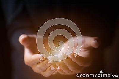 Man hands praying in dark background with faith in religion in God. Power of hope or love Stock Photo