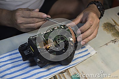 Man Hands Repair Broken Film Camera, Photograph Workplace.Freelance concept work at home. Stock Photo